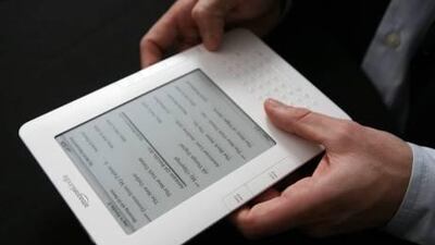 The Kindle 2 electronic reader is shown at an Amazon.com news conference in New York. A reader argues that while paper books are nostalgic, e-readers make for a better reading experience.
