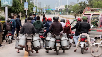 Commuters on motorbikes wait at a roadblock near the Serena Hotel during US–Iran talks in Islamabad. Reuters