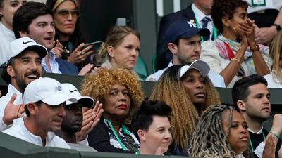 Serena Williams's mother Oracene Price, centre, and sister, Venus Williams, watch as Serena plays France's Harmony Tan in a first-round women's singles match. AP