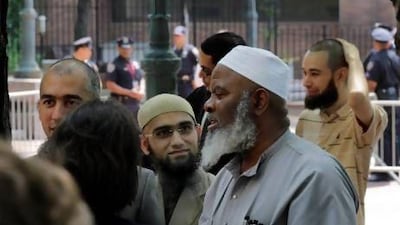 Plaintiffs confer during a gathering in front of New York City Police Department headquarters this week after rights groups filed a case against the police for their unconstitutional spying on American Muslims.