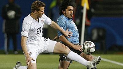 Jonathan Spector of the US slides in on Italy's Gennaro Gattuso during their opening Confederations Cup match in South Africa.