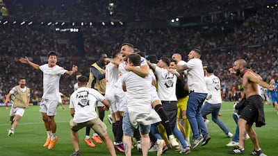 Sevilla's players celebrate with fans. Getty