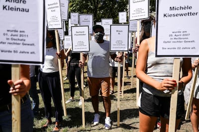 Protesters hold banners with the names of some 220 murdered victims of right-wing terror acts in Germany, as part of a remembrance vigil for the victims of the Halle terror attack, outside the regional court in Magdeburg, Saxony-Anhalt, Germany, 21 July 2020 EPA