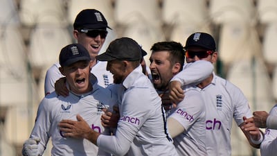 England's Mark Wood celebrates with teammates after the dismissal of Pakistan batter Saud Shakeel. AP