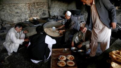 The kitchen staff busy themselves preparing lunch to be served to the factory workers.