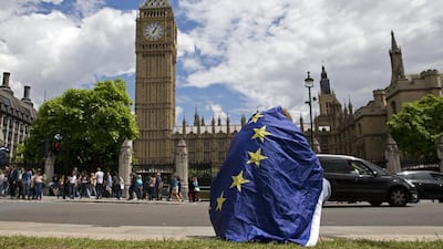 A demonstrator draped in the EU flag protests against the outcome of the UK’s EU referendum in London yesterday. Justin Tallis / AFP