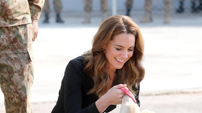 Catherine, Duchess of Cambridge with golden Labrador puppies Salto and Sky as she visits an Army Canine Centre. Getty