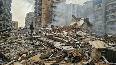 A man stands in the rubble of a building destroyed in an overnight Israeli air strike on Haret Hreik, in Beirut's southern suburbs. AFP