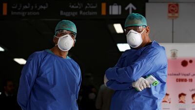 Health officials wait to test passengers at Damascus international airport, Syria March 9, 2020. Reuters