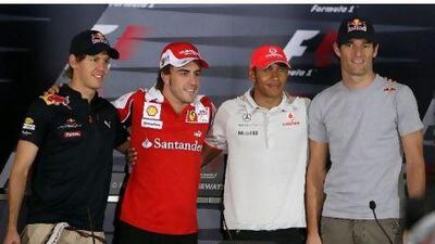 Mark Webber, right, was clearly uncomfortable huddling around his rivals at the press conference in Abu Dhabi yesterday.