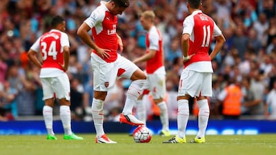 Olivier Giroud and Mesut Ozil of Arsenal react during their Premier League season opening loss to West Ham on Sunday. Julian Finney / Getty Images / August 9, 2015