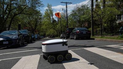 A food delivery robot crosses a street in the Chevy Chase neighbourhood of Washington DC. AFP