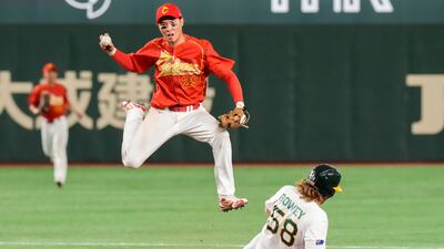 China's Luo Jinjun catches the ball as Australia's Jake Bowey slides into second base during their Pool B game, at the World Baseball Classic, in Tokyo, Japan. AP