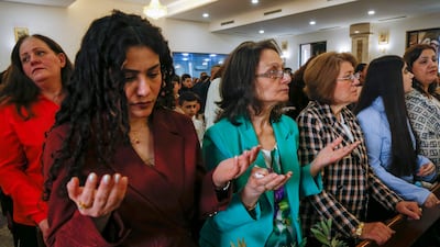 Worshippers attend a Palm Sunday service at the Queen of Peace Church. AFP