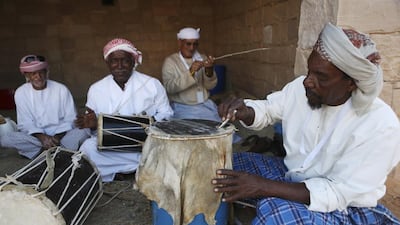 A group of men demonstrate how to make traditional instruments at the Sheikh Zayed Heritage Festival in Al Wathba. Sarah Dea / The National