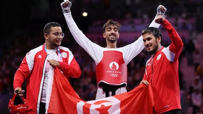 Mohamed Khalil Jendoubi celebrates with his coaches after claiming a bronze medal. Getty Images