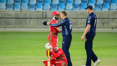Scotland and Oman players greet each other at the end of the game in Dubai. Photo: ICC