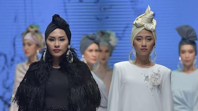 Turbans and asymmetric silhouettes at Ivan Gunawan. AFP