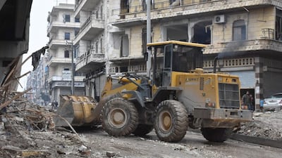 Tractors are seen as the Syrian government starts to clean up areas formerly held by opposition forces in the northern city of Aleppo on December 27, 2016. AFP / George OURFALIAN
