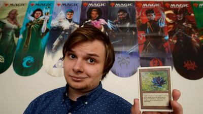 Austin Deceder, who buys and sells cards on Facebook and Twitter, displays a much sought-after Black Lotus 'Magic: The Gathering' card in his home office in Kansas City, Missouri, US. Photo: AP