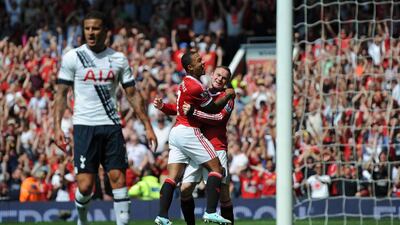 Manchester United's Dutch midfielder Memphis Depay, second from right, celebrates with Wayne Rooney after United take the lead due to an own goal from Tottenham Hotspur's English defender Kyle Walker, left. Oli Scarff / AFP