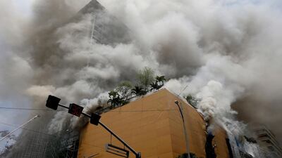 A fire engulfs the Manila Pavilion Hotel and Casino Sunday, March 18, 2018 in Manila, Philippines. The fire hit the hotel, where more than 300 guests were evacuated, some by helicopter, an official said. Bullit Marquez/ AP Photo