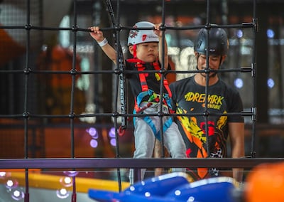 A young child attempts the rope course at Adrenark Adventure indoor park at Al Qana. Victor Besa / The National