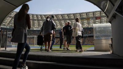 Journalists leave a shelter after an air strike alarm at the NSC Olimpiyskiy stadium during a training session. Reuters