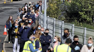 People queue outside a mobile vaccination centre in Bolton, north-west England, amid concern of a rise in cases linked to the Indian Covid variant. Reuters