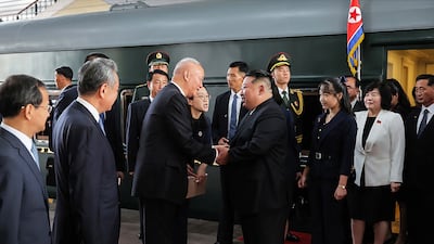 North Korea's leader Kim Jong-un and his daughter Kim Ju Ae being greeted by Chinese officials upon their arrival at the Beijing Railway Station. AFP