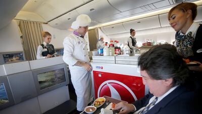 Staff serve a business class meal on a Turkish Airlines flight. Turkey's flag carrier came fourth in the survey. Getty Images