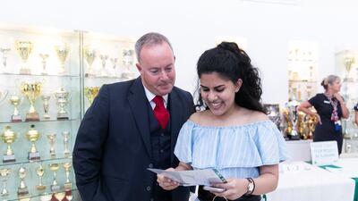 Ebani Dhawan receives her A-Level results, with the prinicipal Simon O’Connor, at Jumeirah College. Reem Mohammed / The National