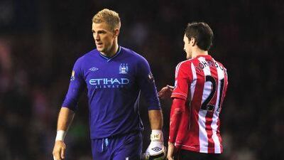 Manchester City goalkeeper Joe Hart is consoled by Adam Johnson.