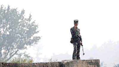 A North Korean soldier stands on the bank of the Yalu River in Sinuiju, North Korea, which borders Dandong in China's Liaoning province