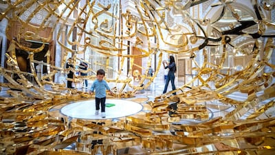 Qasr Al Watan reopened for public tours on Tuesday. Tiago Freites, 2, an Abu Dhabi resident from Venezuela, is amazed by the work of Emirati artist, Mattar Bin Lahej. All photos Victor Besa / The National