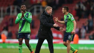 Ronald Koeman (C) manager of Southampton congratulates Dusan Tadic (R) after the Premier League match between Stoke City and Southampton at Britannia Stadium on March 12, 2016 in Stoke on Trent, England. (Photo by Alex Morton/Getty Images)