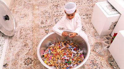 Rashid next to the large vessel of Garangao treats