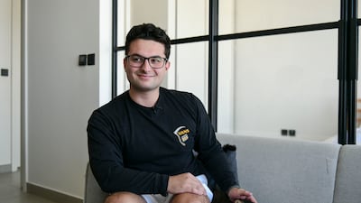 Toby Shaw, 24, with his cat Muteena in his one-bedroom flat at Dubai Hills Estate. All photos: Khushnum Bhandari / The National