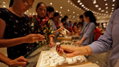Customers looking at gold rings at a showroon in Ahmedabad in October. Sales of gold jewellery in India dropped 32 per cent year-on-year to 101.6 tonnes. Reuters