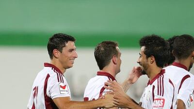 Sebastian Tagliabue, left, is congratulated by his Al Wahda teammates after scoring against Al Nasr at Al Nahyan Stadium, Abu Dhabi. May 10, 2015. Mostafa Reda/Al Ittihad