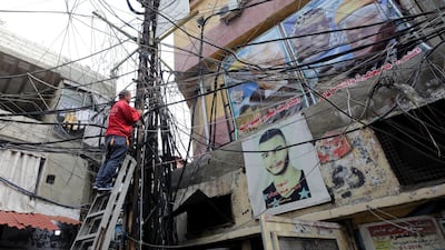 A picture taken on December 21, 2017 shows the labryinth of cables and wires that supply electricity to Burj Al Barajneh. ANWAR AMRO / AFP