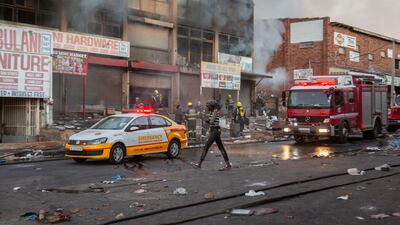 A looted shop on fire in Alexandra township, Johannesburg. At least six people have been killed and more than 200 arrested in the ensuing violence.
