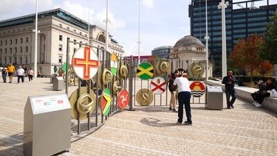 Members of the public pose with flags of the Commonwealth in Birmingham. Getty Images