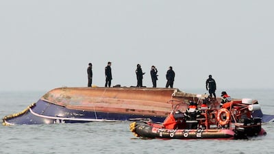 South Korean coastguard members search for missing persons after a fishing boat crashed with a fuel tanker at sea near the western port city of Incheon on December 3, 2017. Yonhap / AFP