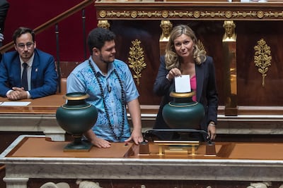 Newly elected youngest member of the Parliament Tematai Le Gayic (L) looks at member of Parliament Yael Braun-Pivet (C) for the Presidential majority l party 'Renaissance' vote for the new Assembly President in the hemicycle of the National Assembly in Paris, France, 28 June 2022. EPA / CHRISTOPHE PETIT TESSON