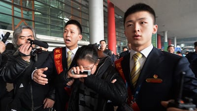A crying woman is escorted to a bus for relatives at the Beijing Airport after news of the missing Malaysia Airlines Boeing 777-200 plane on March 8, 2014. Malaysia Airlines said a flight carrying 239 people from Kuala Lumpur to Beijing went missing early on March 8, and the airline was notifying next of kin in a sign it expected the worst. AFP