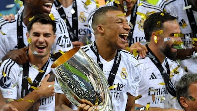 Soccer Football - Super Cup - Real Madrid v Atalanta - National Stadium, Warsaw, Poland - August 14, 2024 Real Madrid's Kylian Mbappe celebrates with the trophy after winning the Super Cup REUTERS / Jennifer Lorenzini TPX IMAGES OF THE DAY