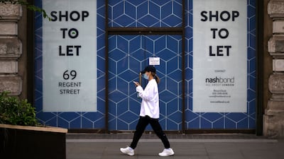 A pedestrian passes a shop to let in London. Global GDP growth is expected to slow to 0.5 per cent in the fourth quarter of the year, according to the IIF. AFP