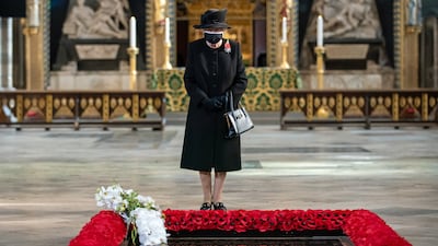 Queen Elizabeth inspects a bouquet of flowers placed on her behalf at the grave of the Unknown Warrior in 2020 to mark the centenary of the burial of the Unknown Warrior
