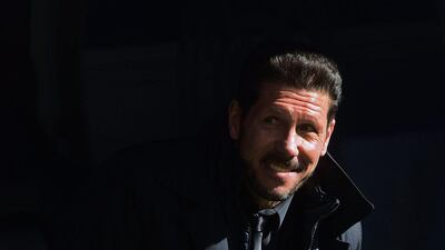 Atletico Madrid's Argentinian coach Diego Simeone smiles during the Spanish league football match Real Madrid CF vs Club Atletico de Madrid at the Santiago Bernabeu stadium in Madrid on February 27, 2016. / AFP / PIERRE-PHILIPPE MARCOU